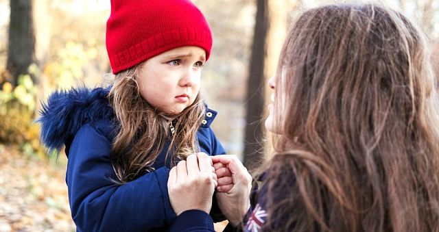 scared-daughter-holding-mothers-hands-in-autumn-park-child-girl-sad-picture-id1068508440.jpg